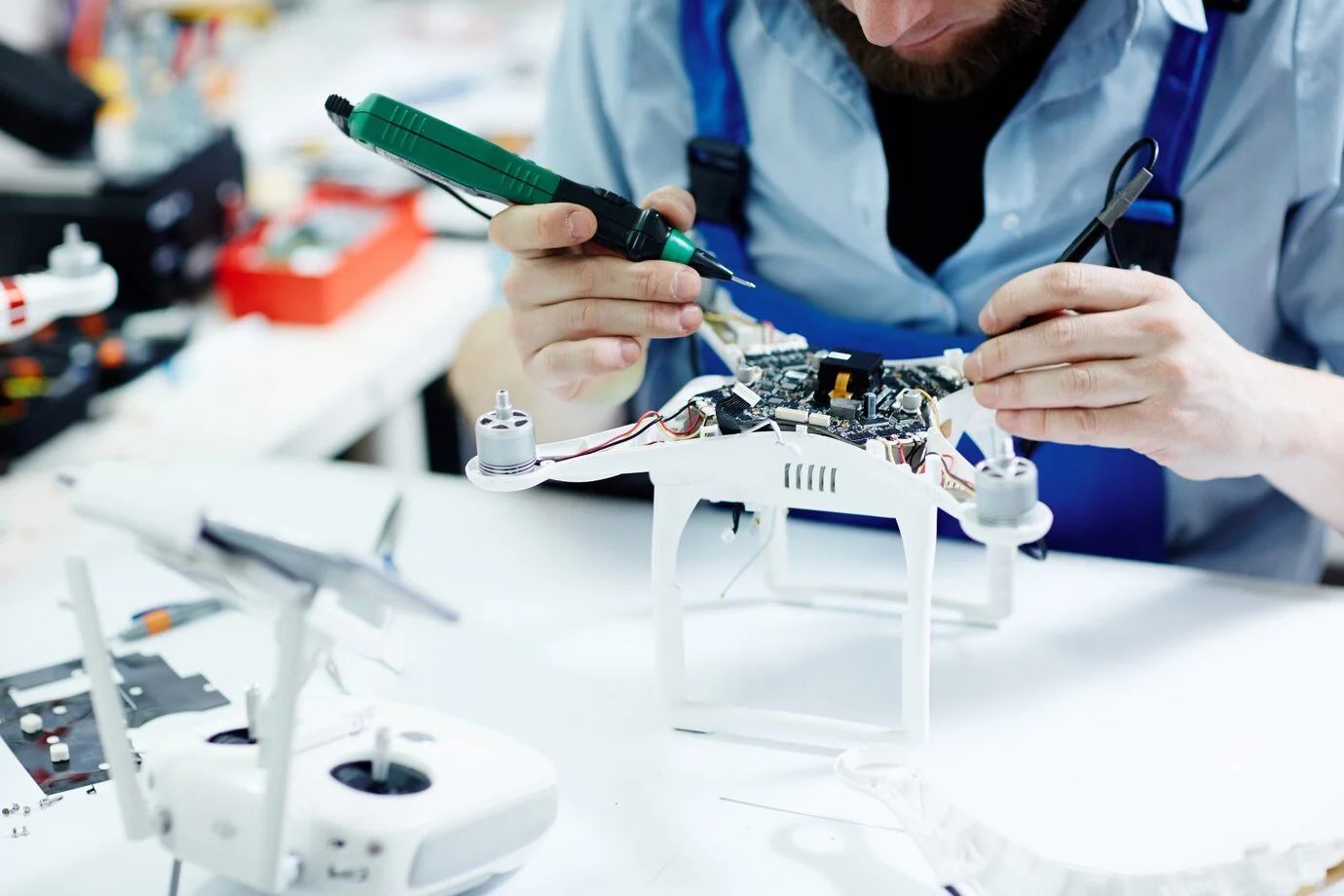 An engineer soldering a quadcopter circuit board