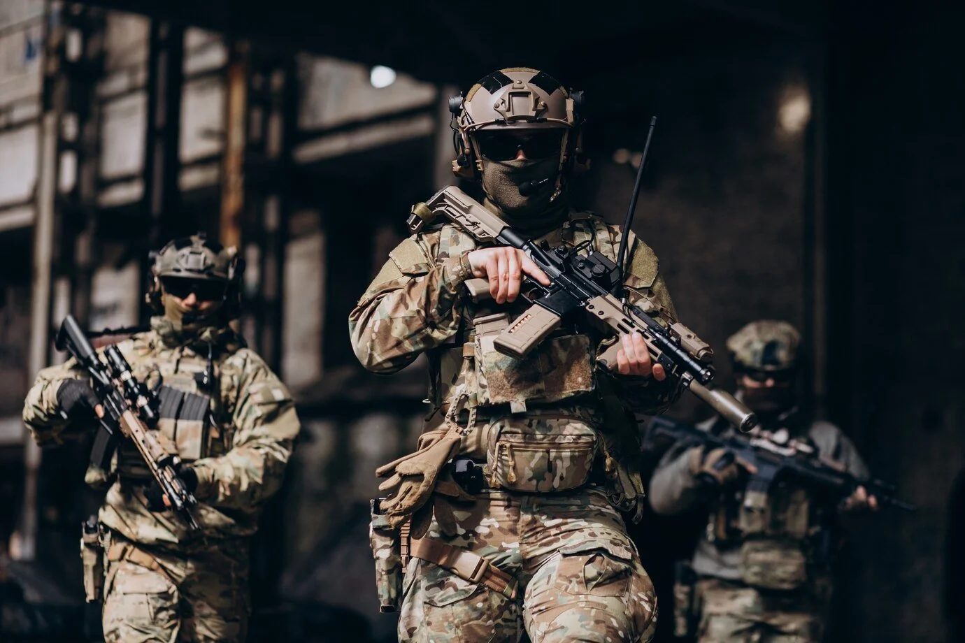 Soldiers in full tactical gear advancing with rifles